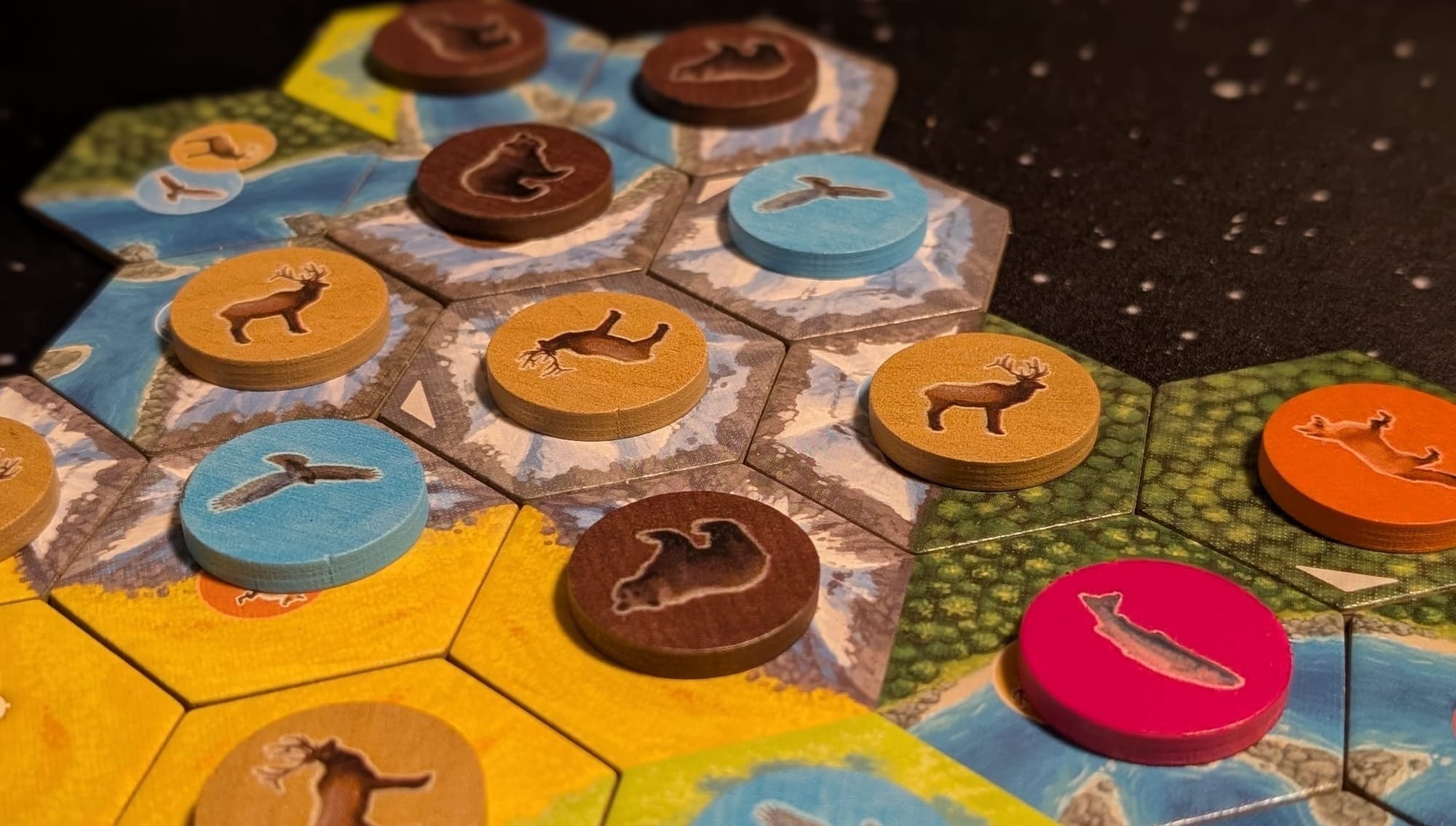 Tiles showing different climates with round animal tokens on each tile.