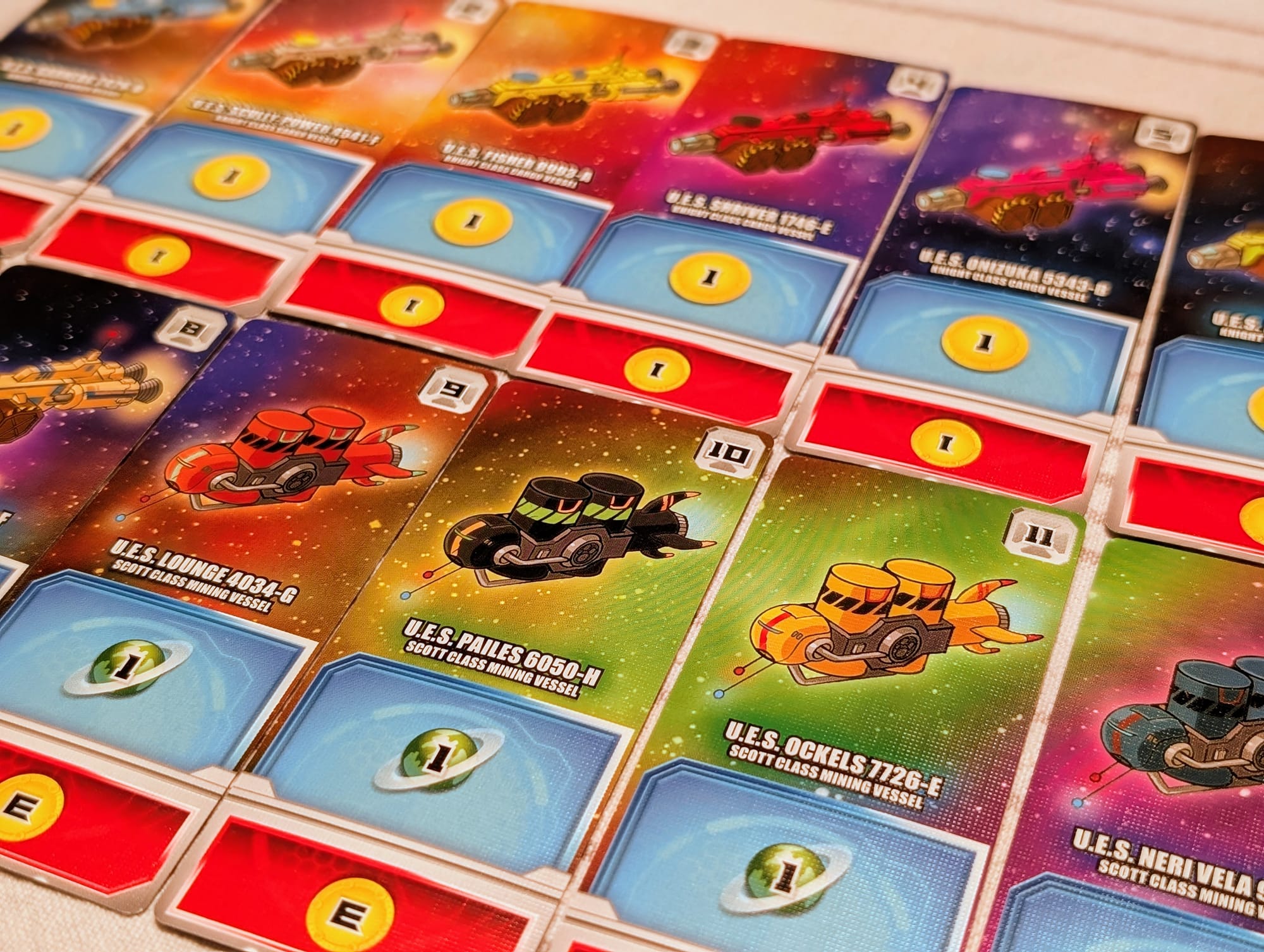 Cards from the game Space Base depicting a bunch of space ships.